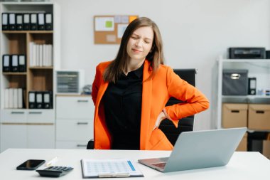 business woman is stressed, bored, and overthinking from working on a tablet at the office.