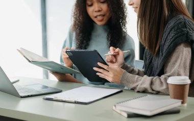  Team work process. Photo young business crew working with new startup project. Project managers meeting. Analyze plans, papers. At office
