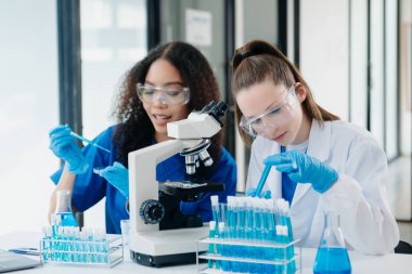 Modern Medical Research Laboratory Portrait of Two African American Scientists Working, Using Digital Tablet, Analyzing Samples, Talking. for Medicine, Biotechnology Developmen