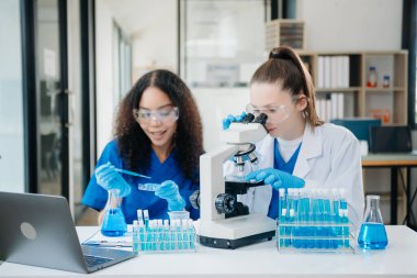 Modern Medical Research Laboratory Portrait of Two African American Scientists Working, Using Digital Tablet, Analyzing Samples, Talking. for Medicine, Biotechnology Developmen