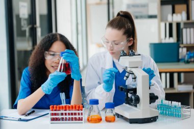 Scientist two woman with tablet and laptop, laboratory and ecofriendly science. Agriculture, research and scientists with online reading, test samples for global warming, analytics 