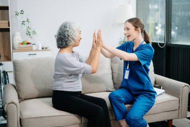 Doctors explain the use of medication to patients. Medical doctor holing senior patient's hands and comforting her on sofa at home