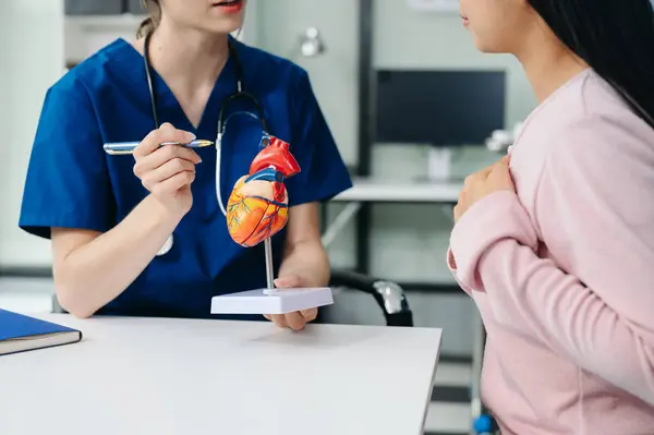  Doctor discussing treatment with Female patient talks to discuss results or symptoms and sitting on examination desk in clinic or hospital