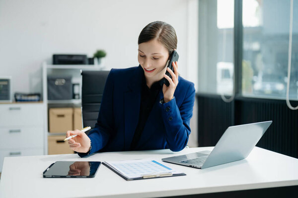 Young attractive female office worker business suits smiling at office