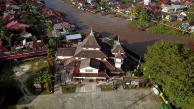 Batı Kalimantan 'daki Sambas Nehri boyunca yoğun yerleşim alanlarının hava manzarası, nehir kıyısında kümelenmiş yapışkan evler, tropikal yaşam tarzını ve yerel mimariyi yansıtıyor..