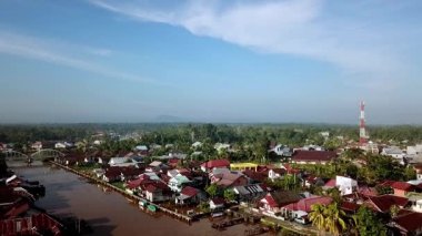 Batı Kalimantan 'daki Sambas Nehri boyunca yoğun yerleşim alanlarının hava manzarası, nehir kıyısında kümelenmiş yapışkan evler, tropikal yaşam tarzını ve yerel mimariyi yansıtıyor..