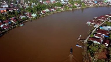 Batı Kalimantan 'daki Sambas Nehri boyunca yoğun yerleşim alanlarının hava manzarası, nehir kıyısında kümelenmiş yapışkan evler, tropikal yaşam tarzını ve yerel mimariyi yansıtıyor..