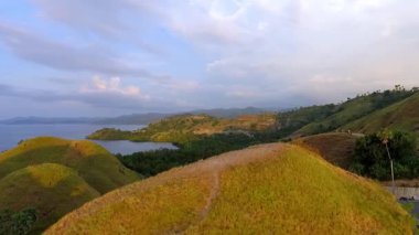 Labuan Bajo, Doğu Nusa Tenggara, Endonezya 'nın havadan görünüşü, Sylvia Hill' den ele geçirilen, kıyı güzelliği, tepe arazisi ve altın öğleden sonra ışığı..