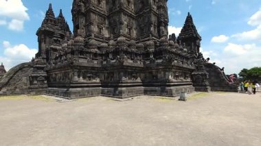 Güneşli bir günde Prambanan tapınak kompleksindeki turist ziyaretlerinin video görüntüsü