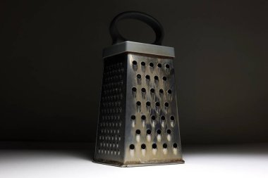 Karanlık Arkaplan Mutfağında Paslanmaz Çelik Öğütücü Çoklu Izgara Taraflı Mutfak Utensili, Aşçılık İçin Minimalist Işıklandırma, Yemek Hazırlama ve Mutfak Aletleri Konsepti