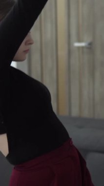 Bir dansçı yavaş, akıcı hareketler yapar, açık-sırt kıyafetinin zarafetini sergiler. Her hareket kontrolün, sanatın ve modern dansın minimalist bir ortamda akışının altını çizer. Yüksek kalite