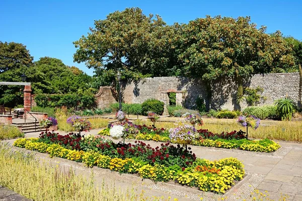 Pretty walled garden inside the grounds of Connaught Gardens, Sidmouth, Devon, UK, Europe