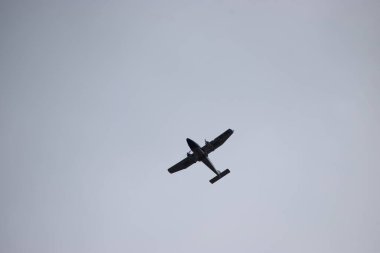 Havada uçan küçük siyah bir uçak.