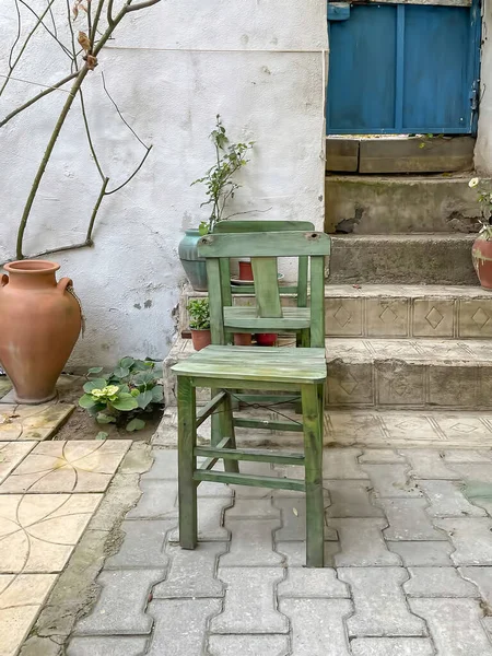 wooden green chairs in the village house and garden