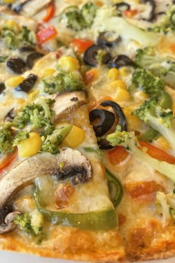 ready-to-eat veggie pizza on plate and in restaurant