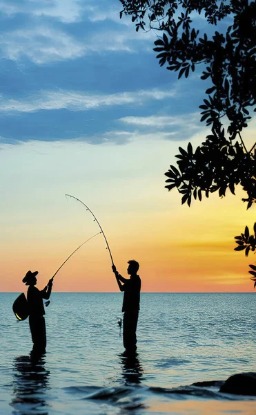 silhouette of people fishing in nature and lake