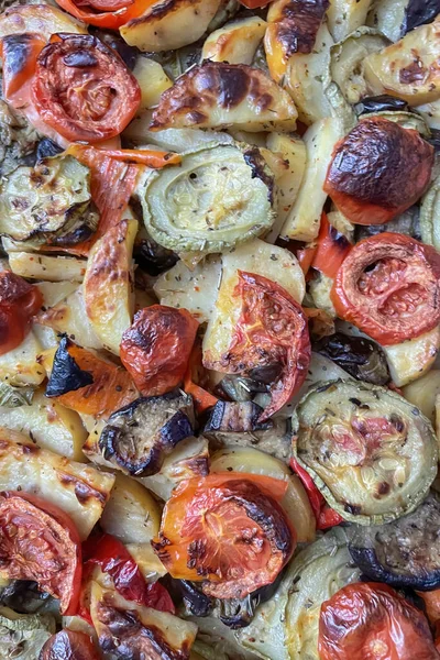 stock image Close up of baked potatoes with eggplant, tomato and onion.