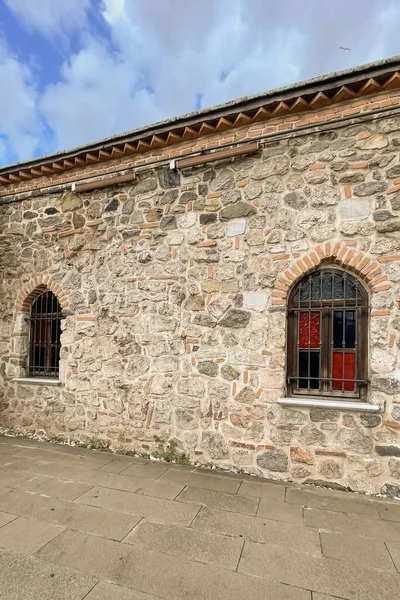 Stone walls and windows of restored historical building