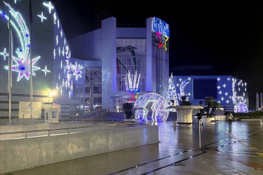 Istanbul,Turkey. December 19,2024.Cevahir Mall in Early December Rain.An early morning scene of the exterior of Mecidiyekoy Cevahir Shopping Center in Istanbul, decorated with festive New Year ornaments on a rainy December day. clipart