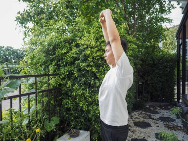 Asyalı çocuk evde yoga egzersizi yapıyor.