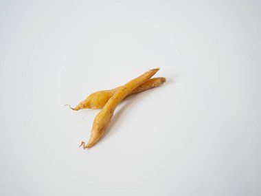 Ayrıntıları ve şekli geliştirmek için yumuşak ışıkla yakalanan parmak kökünden bir çift rizom yan yana dizilmiş..