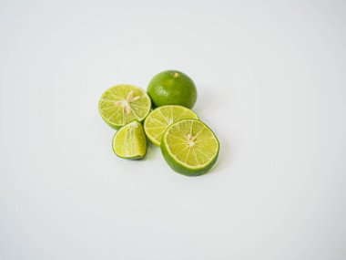 Tam ve dilimlenmiş kireç, tropikal ve sağlıklı markalaşma için dengeli üçlü stilde sergilenir.