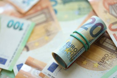 20 avroluk banknotların rulosu 150 avroluk banknotların üzerinde yatıyor.