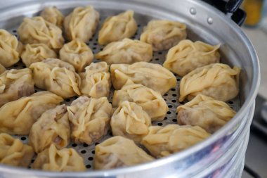 Kyrgyz ravioli cooked with steam in a pot, homemade ravioli,