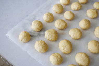 large quantities of raw pastry dough balls,
