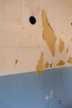 paint peeling off of the old building,