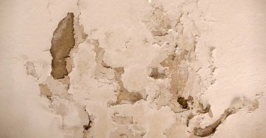 paint peeling off of the old building, paint peeling on the wall, spilling paint on the walls,