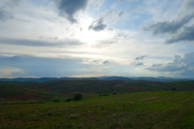 Bulutlu gökyüzü ve yeşil manzara, harika bahar manzarası, yeşil tarla ve tepe manzarası,