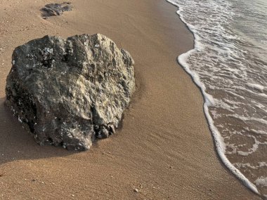 Sahilde kayalar ve beyaz köpük dalgaları