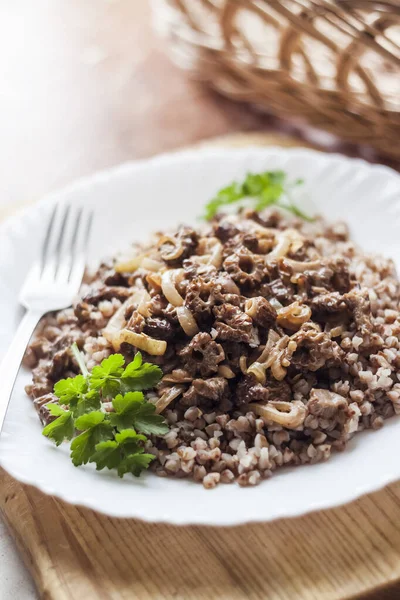 stock image Spring Morel mushrooms stewed in sour cream, served with buckwheat on white plate