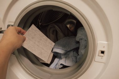 Çamaşır makinesinin variline konmadan önce renk yakalayan çarşaf. Yüksek kalite fotoğraf