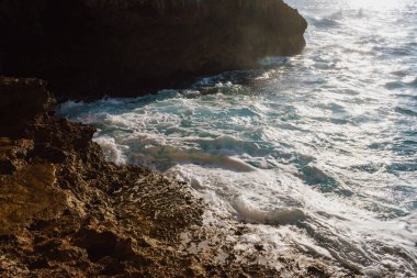 Yazın güneşli bir günde mağaradan denize bakmak. Akdeniz güzellik manzarası. Dalgalar kayalık bir plaja çarpıyor. Yüksek kalite fotoğraf