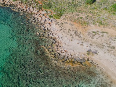 Rocky coastline on Crete island featuring crystal clear azure sea water, Mediterranean seascape and coastal beauty in warm sunny summer weather