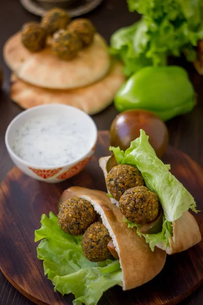 Falafel and pita sandwich on a table