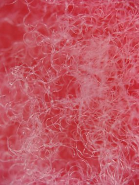 Pembe sentetik ipliğin pürüzsüz, parlak bir dokusu var. Soyut şablonlar ve parlak renkler onu yaratıcı ve desenli stok fotoğrafları için mükemmel kılıyor..