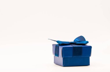 Kopyalama alanı ve beyaz arkaplanı olan mavi bir hediye kutusunun yatay fotoğrafı