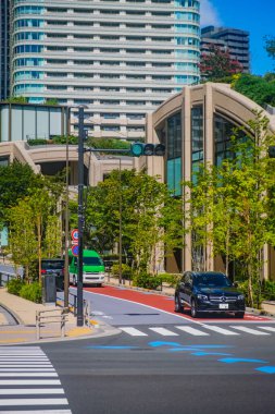 Tokyo, Japonya - 14 Eylül 2024: Azabudai Hills 'te şehir binaları, araçlar ve çağdaş mimariyle doğayı harmanlayan yemyeşil alanlar sergileniyor.