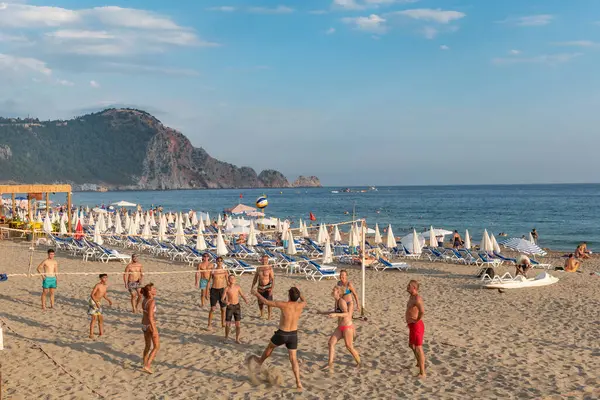 Alanya, Türkiye. 9 Temmuz 2024 Türkiye 'nin Akdeniz kıyısındaki Türkiye tatil beldesi Alanya' daki Kleopatra Plajı 'nda voleybol oynayan tatilciler, Türk Rivierası. 