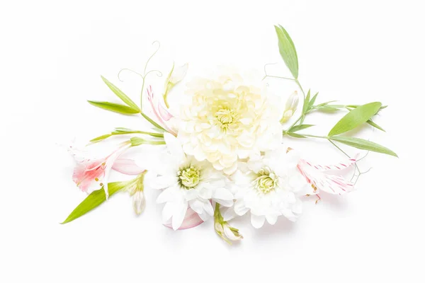 Delicate flower arrangement with flowers chrysanthemums and green leaves. Floral festive background. Copy space, flat lay. top view