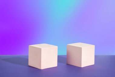 Cosmetic violet gradient background with geometric shapes. Two cement cubic podiums. Mockup for the demonstration of cosmetic products.