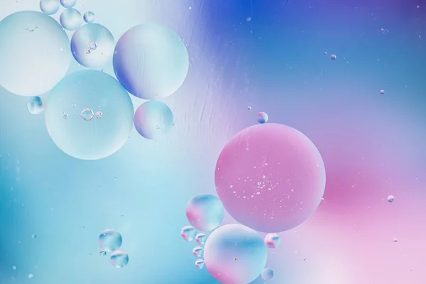 Distortion in water with oil drops. cosmetic bubbles background for advertising products. gradient