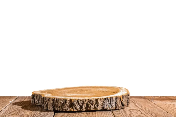 stock image Country style. Round cut of a tree on a wooden table isolate on a white background. Podium for the presentation and sale of natural products. Copy space