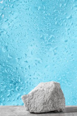 Podium texture stone for presentation on a blue dewy background. still life for layout. Copy space clipart