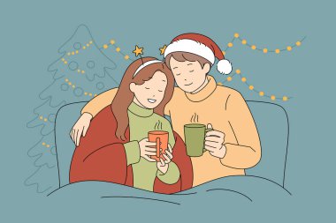 A couple joyfully wrapped in a cozy blanket, cheerfully raising their mugs during the cheerful festive season