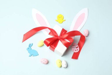 Beyaz arka planda renkli yumurtaları, tavşanı ve tavşanı olan şirin bir Paskalya tavşanı.