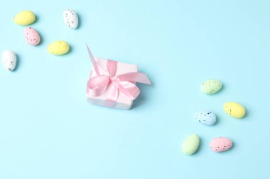 Paskalya yumurtaları ve pembe arka planda dekoratif tavşancık..